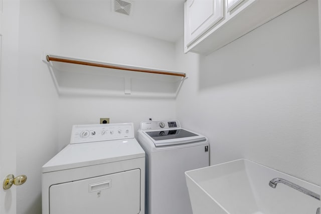 9320 Vista Cir, Irving, TX 75063 - laundry area with cabinet space and washing machine and clothes dryer
