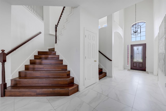 9320 Vista Cir, Irving, TX 75063 - foyer entrance featuring stairway, a high ceiling, a chandelier, and marble finish flooring