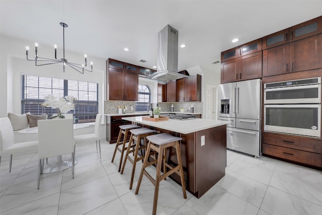 9320 Vista Cir, Irving, TX 75063 - kitchen featuring appliances with stainless steel finishes, island exhaust hood, a chandelier, light countertops, and a center island