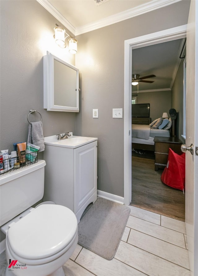 198 Seven Pines Rd, Benton, LA 71006 - ensuite bathroom featuring crown molding, toilet, vanity, a ceiling fan, and baseboards