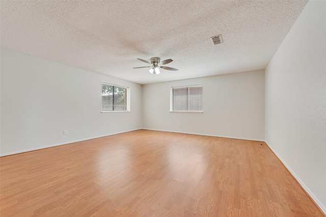 7616 Jamie Renee Ln, North Richland Hills, TX 76182 - spare room with ceiling fan, light wood finished floors, a textured ceiling, and baseboards