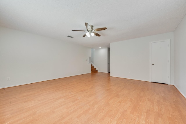 7616 Jamie Renee Ln, North Richland Hills, TX 76182 - empty room featuring ceiling fan, light wood-type flooring, stairs, and baseboards
