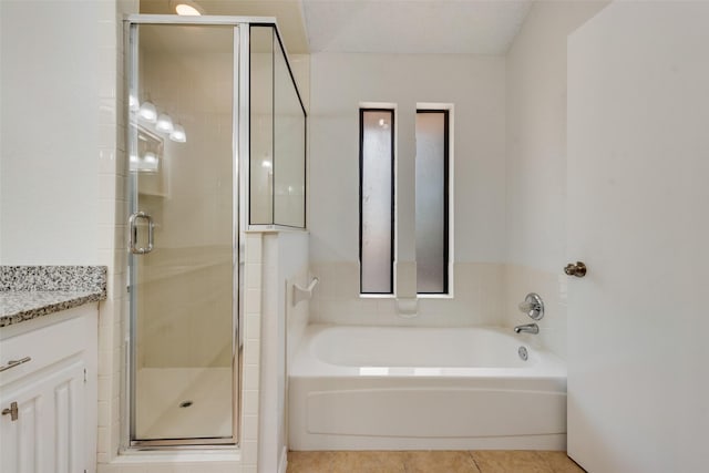 7616 Jamie Renee Ln, North Richland Hills, TX 76182 - bathroom with vanity, a garden tub, a stall shower, and tile patterned floors