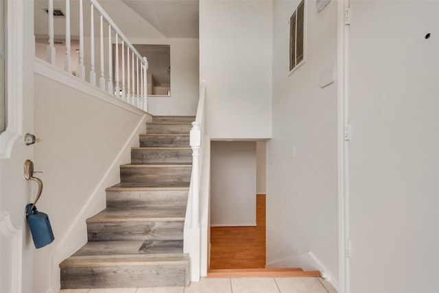 7616 Jamie Renee Ln, North Richland Hills, TX 76182 - stairway featuring tile patterned floors and baseboards