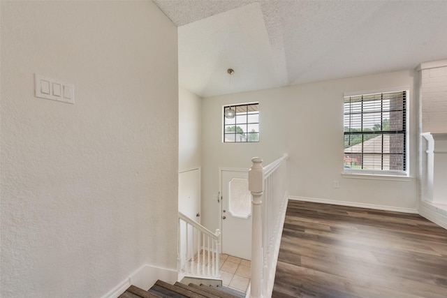 7616 Jamie Renee Ln, North Richland Hills, TX 76182 - foyer with wood finished floors, a textured ceiling, baseboards, and lofted ceiling