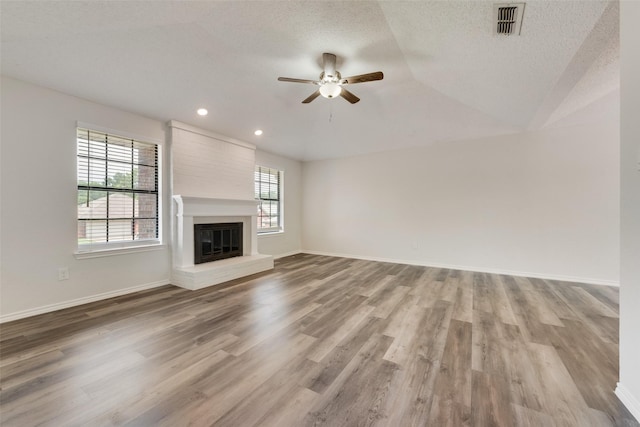 7616 Jamie Renee Ln, North Richland Hills, TX 76182 - unfurnished living room featuring a ceiling fan, wood finished floors, a fireplace, baseboards, and recessed lighting