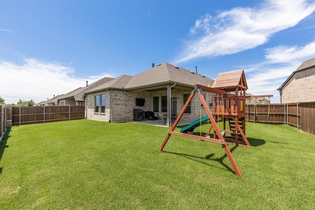 3817 Stonewood Dr, Little Elm, TX 75068 - rear view of house featuring a playground, a shingled roof, and brick siding