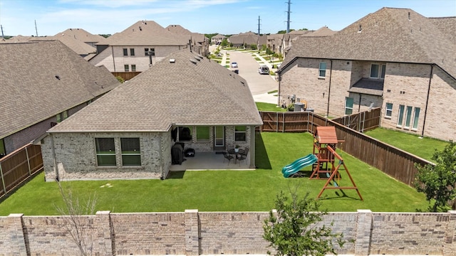 3817 Stonewood Dr, Little Elm, TX 75068 - back of property with a shingled roof, a patio, a playground, and a residential view