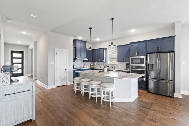 3817 Stonewood Dr, Little Elm, TX 75068 - kitchen featuring stainless steel appliances, a sink, backsplash, a kitchen breakfast bar, and a kitchen island