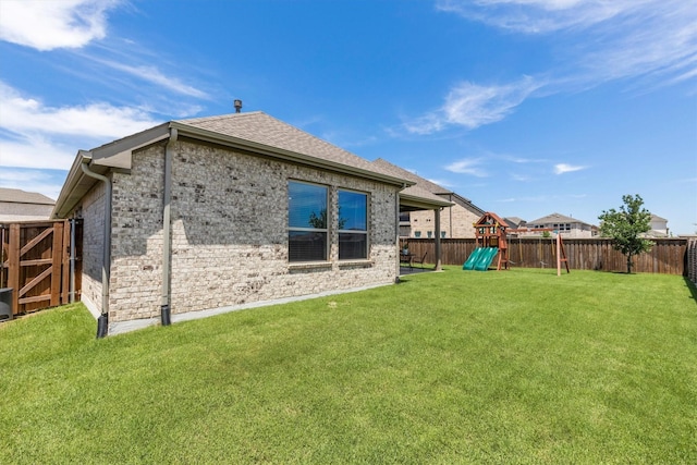 3817 Stonewood Dr, Little Elm, TX 75068 - rear view of property featuring a playground, roof with shingles, and brick siding