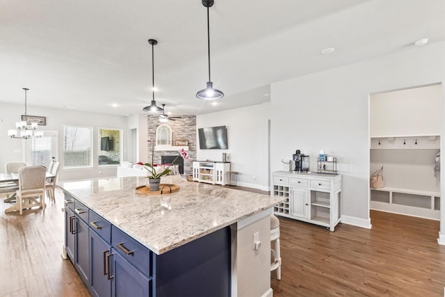 3817 Stonewood Dr, Little Elm, TX 75068 - kitchen with blue cabinetry, a fireplace, dark wood-style floors, and ceiling fan
