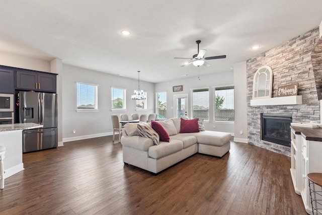 3817 Stonewood Dr, Little Elm, TX 75068 - living area featuring baseboards, a fireplace, a ceiling fan, dark wood-style flooring, and a chandelier