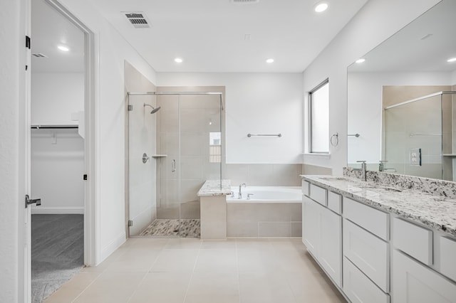 4251 Arlington Ave, Mckinney, TX 75071 - bathroom with a stall shower, a bath, vanity, a walk in closet, and recessed lighting