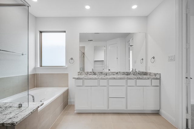 4251 Arlington Ave, Mckinney, TX 75071 - full bath featuring double vanity, a garden tub, a stall shower, baseboards, and tile patterned floors