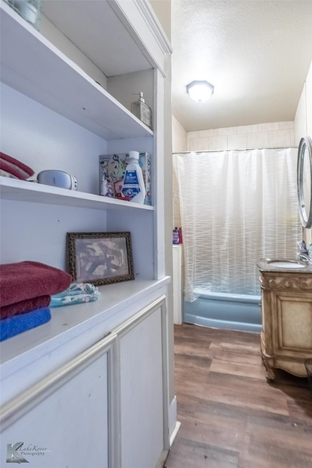 890 Vine St, Abilene, TX 79602 - bathroom with vanity, wood finished floors, and a textured ceiling