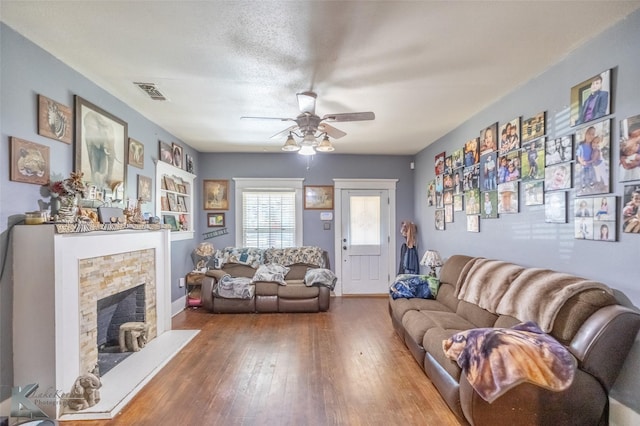 890 Vine St, Abilene, TX 79602 - living area with a ceiling fan, a stone fireplace, and hardwood / wood-style floors