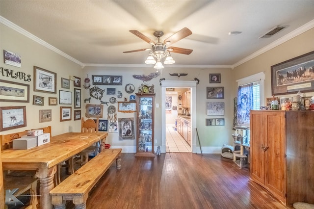 890 Vine St, Abilene, TX 79602 - dining room featuring dark wood-style flooring, a ceiling fan, crown molding, and baseboards