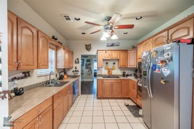 890 Vine St, Abilene, TX 79602 - kitchen with black appliances, a sink, ceiling fan, light countertops, and light tile patterned flooring