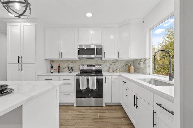 1427 Oriole Blvd, Duncanville, TX 75116 - kitchen featuring appliances with stainless steel finishes, a sink, recessed lighting, healthy amount of natural light, and decorative backsplash