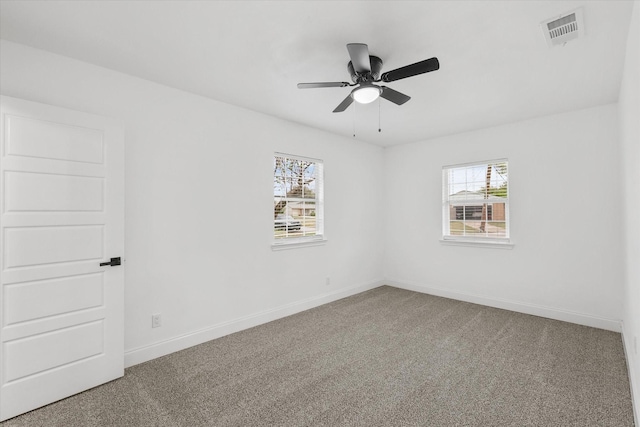 1427 Oriole Blvd, Duncanville, TX 75116 - carpeted empty room featuring plenty of natural light, baseboards, and ceiling fan