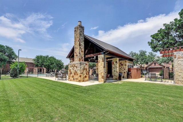4721 Bayview Dr, Plano, TX 75093 - rear view of house featuring stone siding, a chimney, a patio, and metal roof