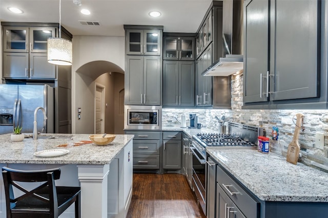 5913 Lewis St, Dallas, TX 75206 - kitchen featuring appliances with stainless steel finishes, a sink, light stone countertops, backsplash, and recessed lighting