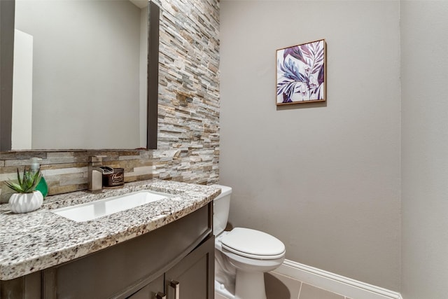 5913 Lewis St, Dallas, TX 75206 - bathroom with vanity, toilet, tile patterned floors, baseboards, and tasteful backsplash