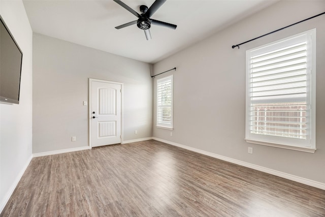 760 E Northside Dr, Pilot Point, TX 76258 - unfurnished room with wood finished floors, a ceiling fan, and baseboards