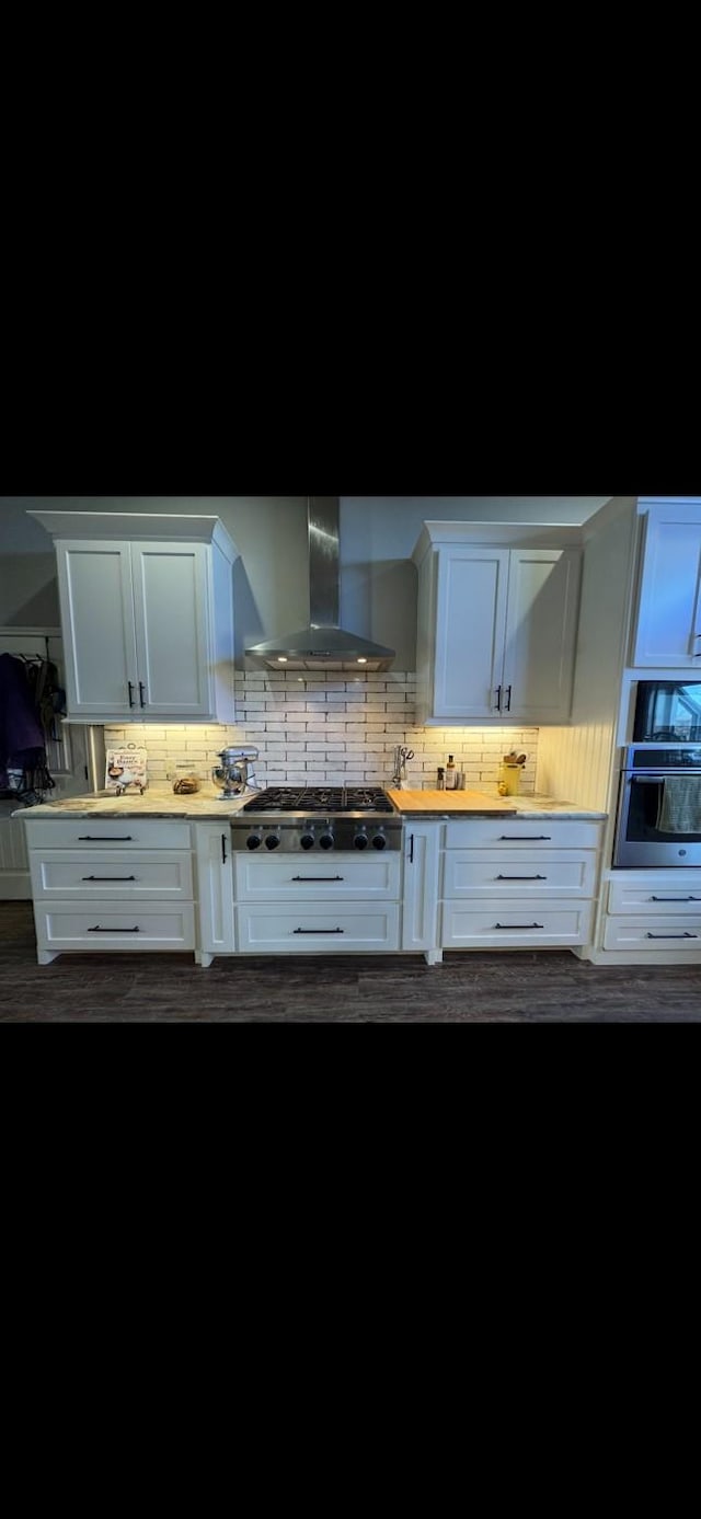 760 E Northside Dr, Pilot Point, TX 76258 - kitchen with wall chimney exhaust hood, appliances with stainless steel finishes, backsplash, white cabinets, and light countertops