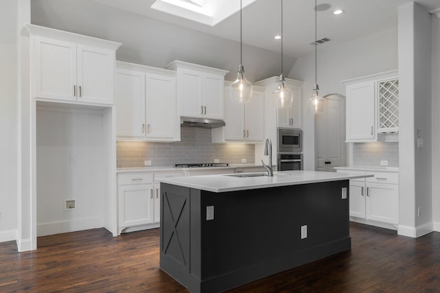 7340 San Felipe Dr, Irving, TX 75039 - kitchen featuring a sink, under cabinet range hood, tasteful backsplash, white cabinetry, and recessed lighting