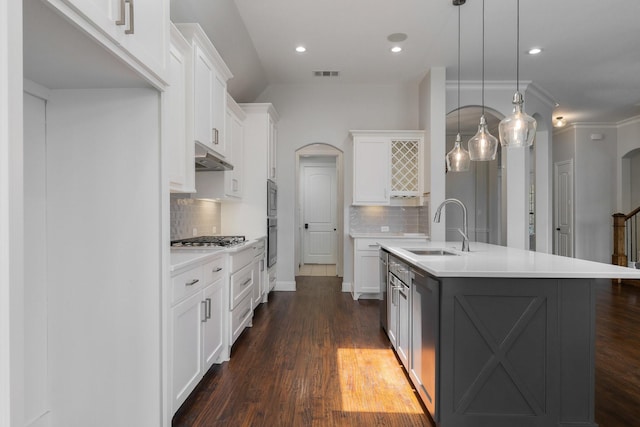 7340 San Felipe Dr, Irving, TX 75039 - kitchen featuring arched walkways, a sink, appliances with stainless steel finishes, tasteful backsplash, and recessed lighting