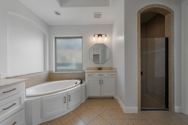 7340 San Felipe Dr, Irving, TX 75039 - bathroom with tile patterned flooring, vanity, a bath, a stall shower, and baseboards