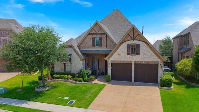 7340 San Felipe Dr, Irving, TX 75039 - tudor-style house with stone siding, roof with shingles, a garage, a front lawn, and driveway