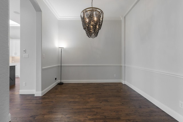 7340 San Felipe Dr, Irving, TX 75039 - spare room with arched walkways, a chandelier, dark wood-style floors, crown molding, and baseboards