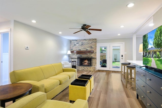 909 Redwood Dr, Richardson, TX 75080 - living area featuring a ceiling fan, light wood-style floors, recessed lighting, ornamental molding, and a fireplace