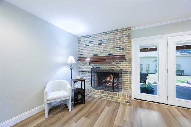 909 Redwood Dr, Richardson, TX 75080 - sitting room with wood finished floors, baseboards, and a fireplace