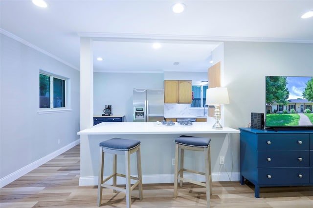 909 Redwood Dr, Richardson, TX 75080 - kitchen featuring stainless steel refrigerator with ice dispenser, crown molding, light wood-style floors, a peninsula, and tasteful backsplash