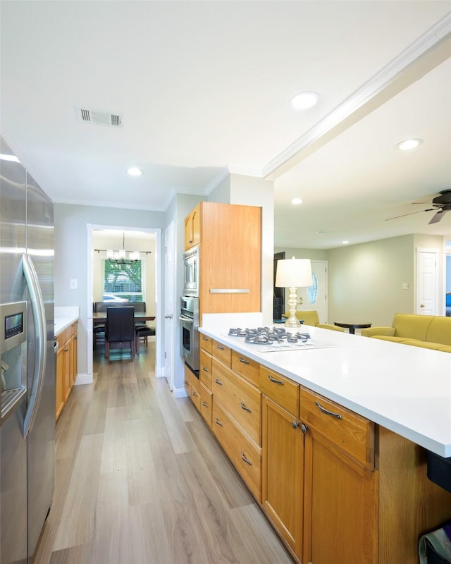 909 Redwood Dr, Richardson, TX 75080 - kitchen featuring appliances with stainless steel finishes, light wood-style flooring, light countertops, ornamental molding, and recessed lighting