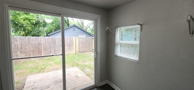 1806 Maryland Ave, Dallas, TX 75216 - doorway featuring baseboards and a textured wall