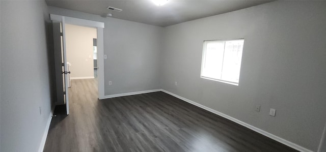 1806 Maryland Ave, Dallas, TX 75216 - unfurnished room featuring dark wood-style flooring and baseboards