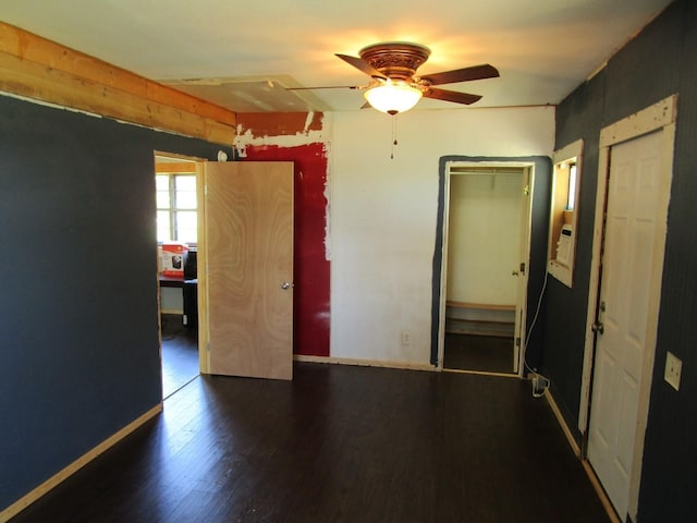 841 S 5th Ave, Munday, TX 76371 - unfurnished bedroom featuring wood finished floors, ceiling fan, and baseboards