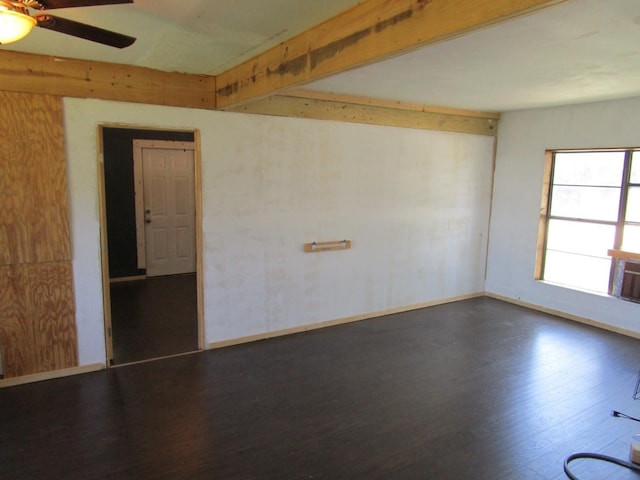 841 S 5th Ave, Munday, TX 76371 - spare room featuring wood finished floors, a ceiling fan, and baseboards