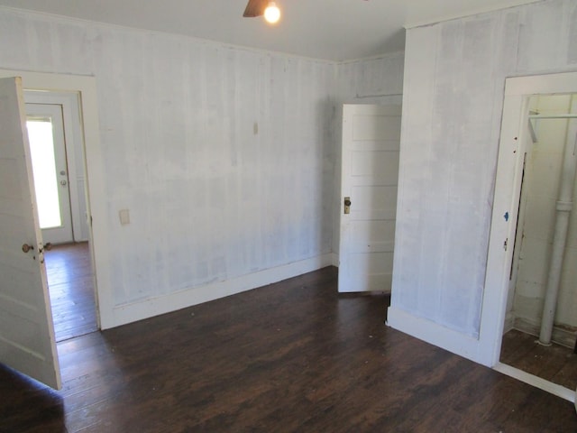 841 S 5th Ave, Munday, TX 76371 - empty room featuring wood finished floors, baseboards, and a ceiling fan