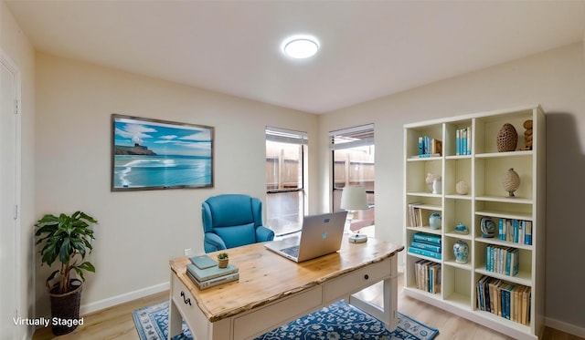 6916 Moccasin Dr, Plano, TX 75023 - home office featuring light wood-type flooring and baseboards