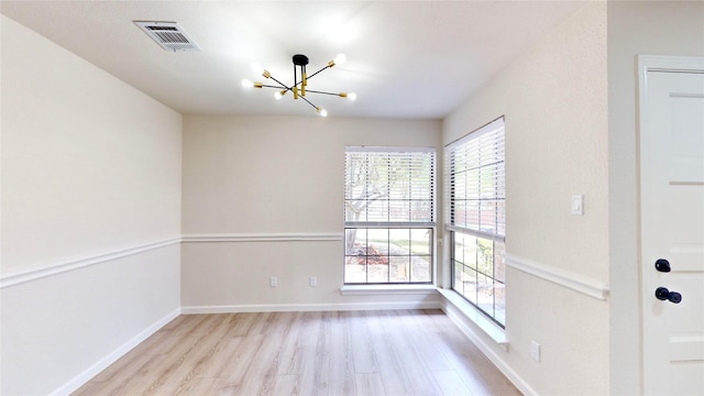 6916 Moccasin Dr, Plano, TX 75023 - unfurnished dining area with a chandelier, wood finished floors, and baseboards