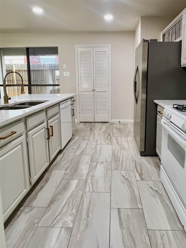 6916 Moccasin Dr, Plano, TX 75023 - kitchen with white appliances, a sink, light countertops, recessed lighting, and light marble finish flooring
