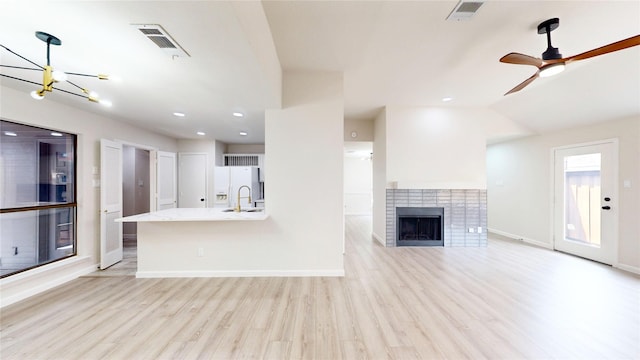 6916 Moccasin Dr, Plano, TX 75023 - unfurnished living room featuring light wood-style floors, baseboards, a chandelier, a fireplace, and recessed lighting