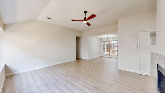 6916 Moccasin Dr, Plano, TX 75023 - unfurnished living room featuring ceiling fan, a fireplace, light wood finished floors, baseboards, and lofted ceiling