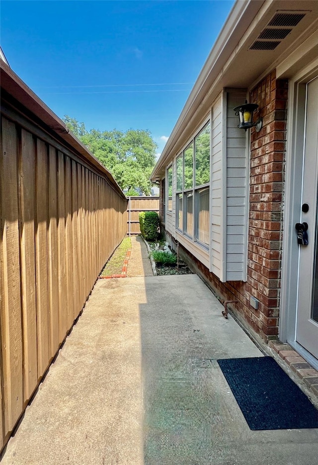 6916 Moccasin Dr, Plano, TX 75023 - view of side of property with brick siding and a patio