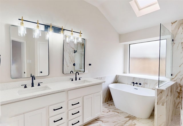 6916 Moccasin Dr, Plano, TX 75023 - full bathroom featuring vaulted ceiling, a skylight, a marble finish shower, marble finish flooring, and a freestanding bath